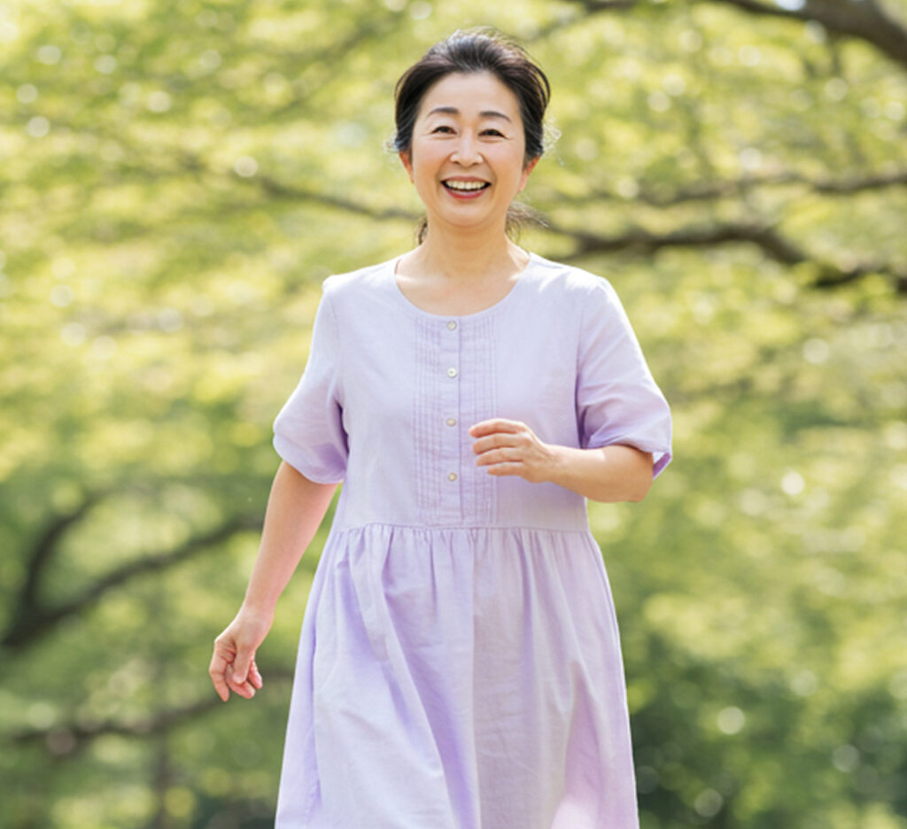 Smiling woman walking outdoors aiming for posture correction and body improvement
